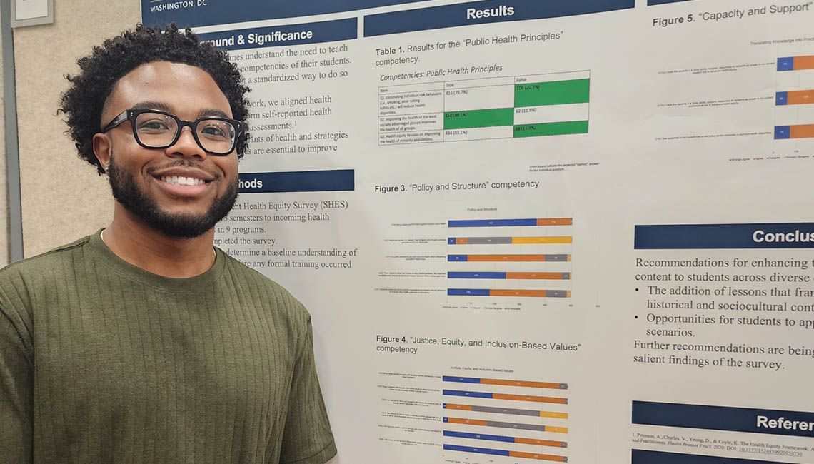 student with research poster