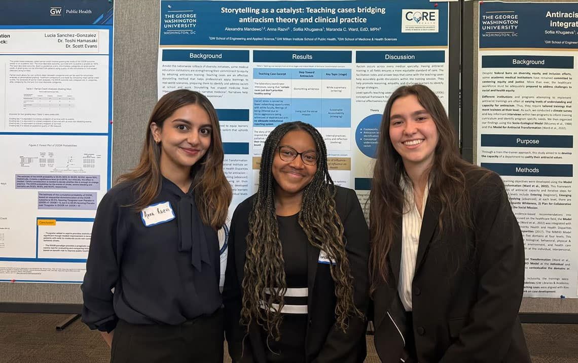 Alexandra Mandewo, Sofia Khugaeva, and Anna Razvi standing with their presentation poster 